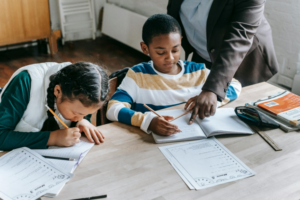 teacher helping a student with work